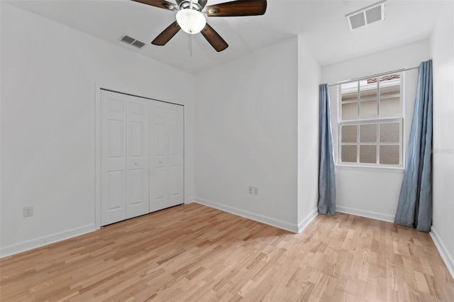 unfurnished bedroom featuring light wood finished floors, baseboards, and visible vents