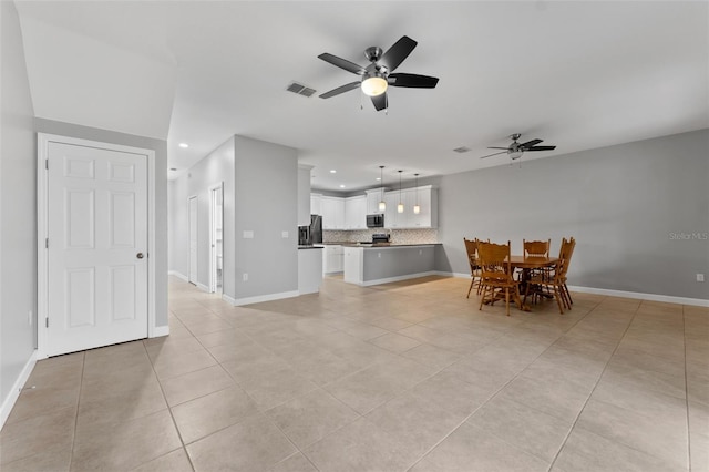 interior space with light tile patterned floors, visible vents, and baseboards