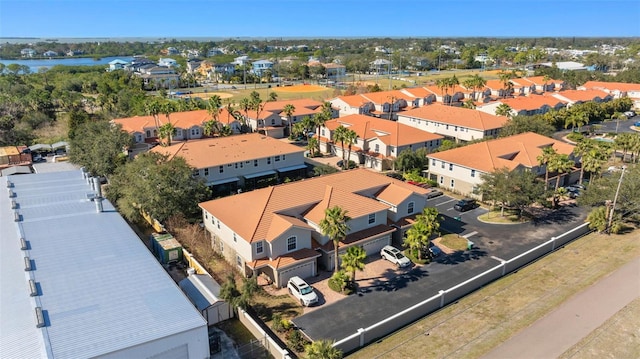 drone / aerial view with a water view and a residential view