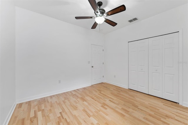 unfurnished bedroom with ceiling fan, light wood finished floors, visible vents, and baseboards