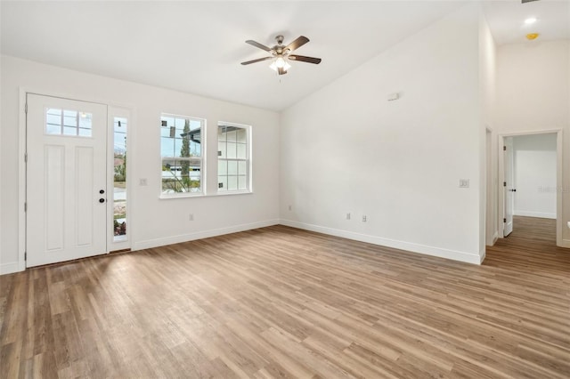 entrance foyer featuring high vaulted ceiling, ceiling fan, and light wood-type flooring