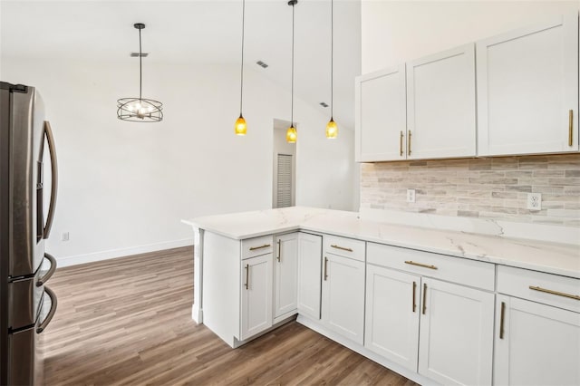 kitchen with white cabinetry, hanging light fixtures, light stone countertops, stainless steel fridge with ice dispenser, and kitchen peninsula