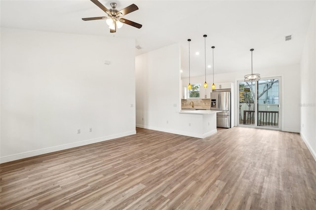 unfurnished living room with ceiling fan and light hardwood / wood-style floors