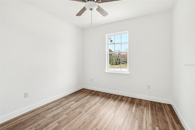 empty room with ceiling fan and light wood-type flooring