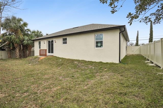 rear view of house with a lawn