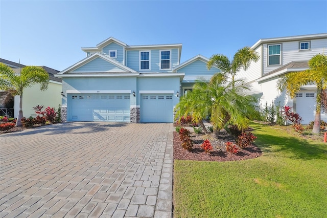 view of front of house featuring a garage and a front lawn