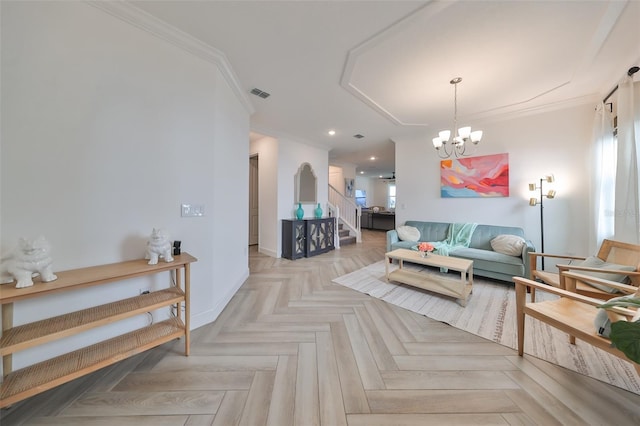 living room featuring light parquet flooring, crown molding, and a notable chandelier