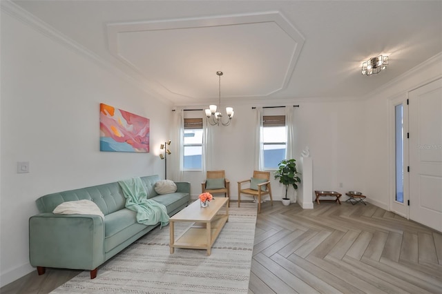 living room featuring crown molding, an inviting chandelier, and light parquet floors