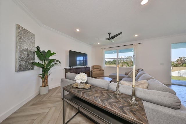 living room featuring a healthy amount of sunlight, crown molding, and light parquet flooring