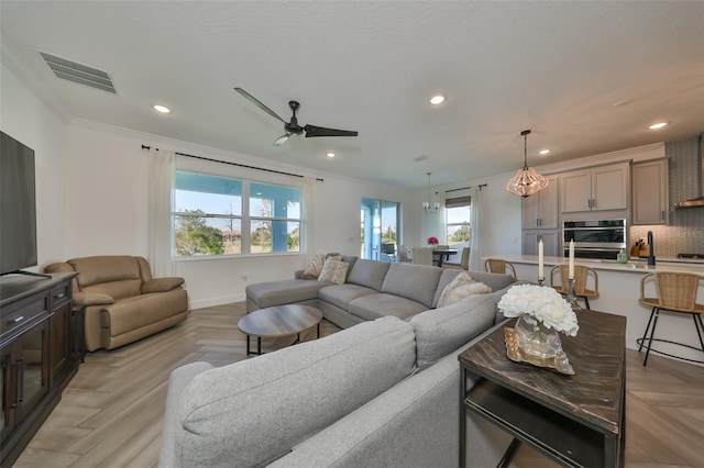 living room featuring crown molding, ceiling fan, and light parquet flooring