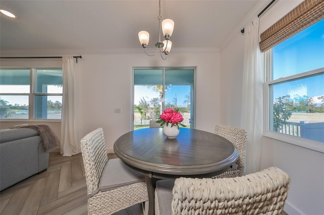 dining space featuring an inviting chandelier, parquet flooring, and ornamental molding