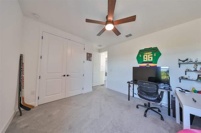 home office featuring ceiling fan and light colored carpet
