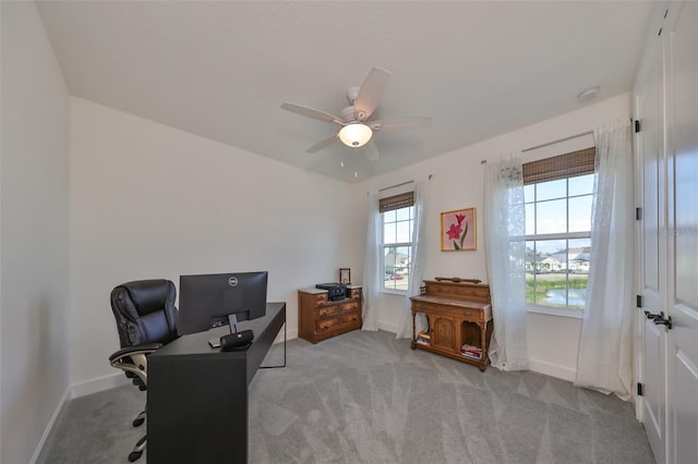 office area with light colored carpet and ceiling fan