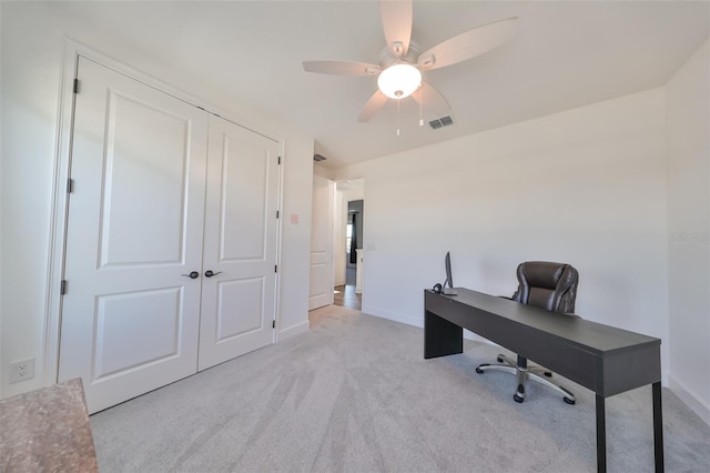 home office with ceiling fan and light carpet