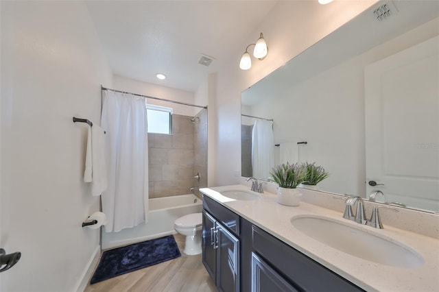 full bathroom featuring shower / bathtub combination with curtain, vanity, wood-type flooring, and toilet