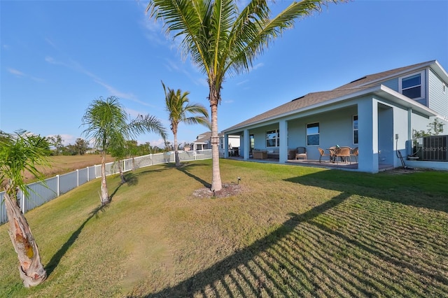 view of yard featuring central AC and a patio area