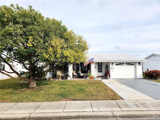 view of front of home featuring a garage and a front yard