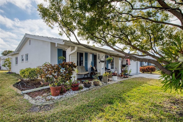 ranch-style home with a garage, covered porch, and a front yard