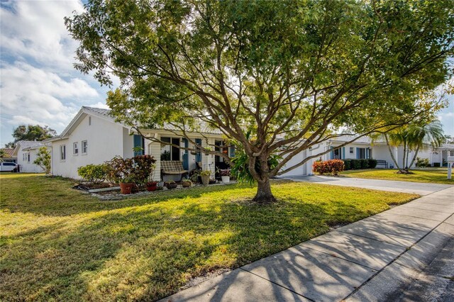 ranch-style home with a garage and a front lawn