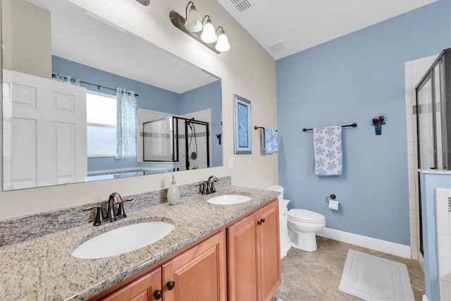 bathroom with vanity, toilet, and a shower with shower door