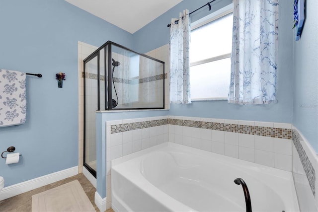 bathroom featuring independent shower and bath and tile patterned flooring