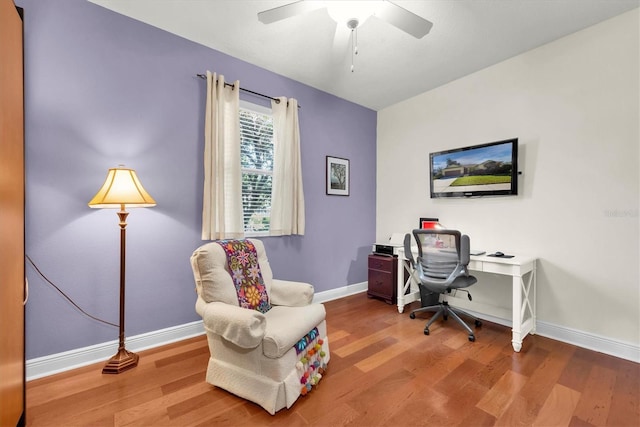 home office featuring wood-type flooring and ceiling fan