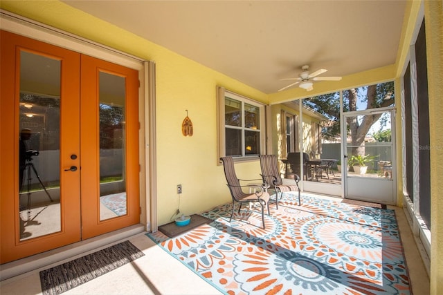 sunroom / solarium featuring french doors and ceiling fan