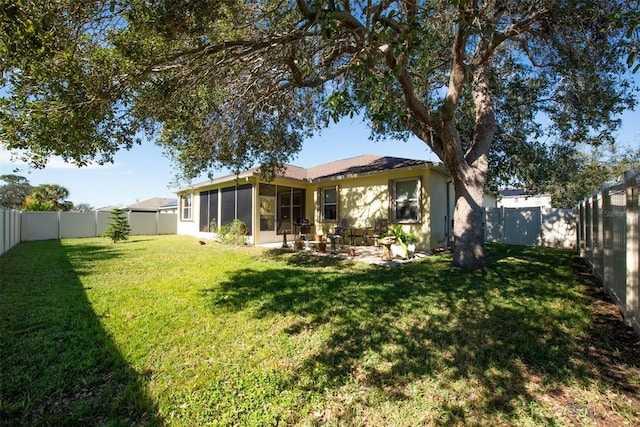 back of house with a yard and a patio