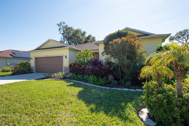 view of front of home with a garage and a front lawn