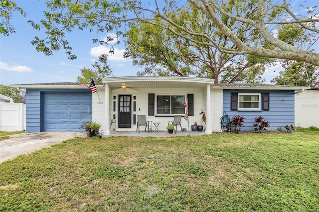 ranch-style home with a garage, a front yard, and a porch