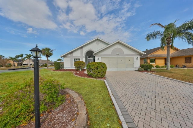 single story home with a garage and a front lawn