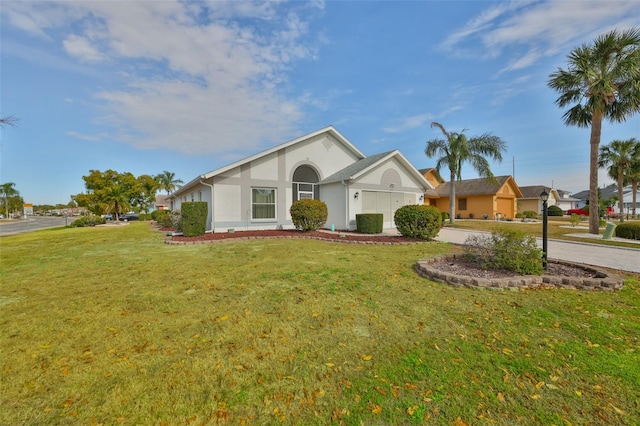 ranch-style home featuring a garage and a front lawn