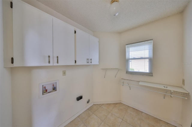 laundry area with cabinets, hookup for a washing machine, and a textured ceiling