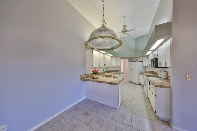 kitchen with pendant lighting, white cabinets, white appliances, and kitchen peninsula