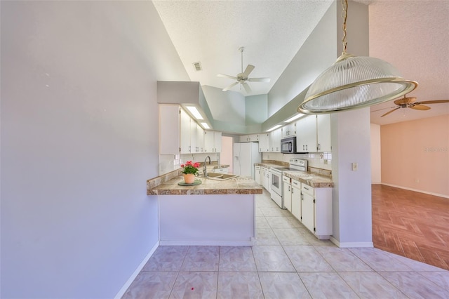 kitchen featuring decorative light fixtures, sink, white cabinets, kitchen peninsula, and white appliances