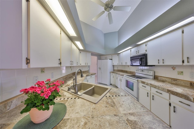 kitchen featuring a high ceiling, white appliances, white cabinetry, sink, and backsplash