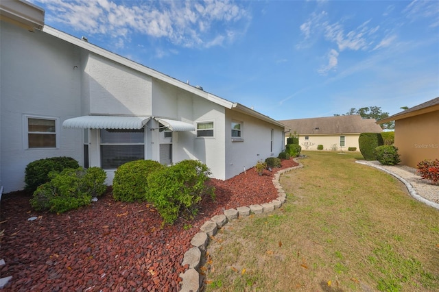 view of side of home featuring a lawn