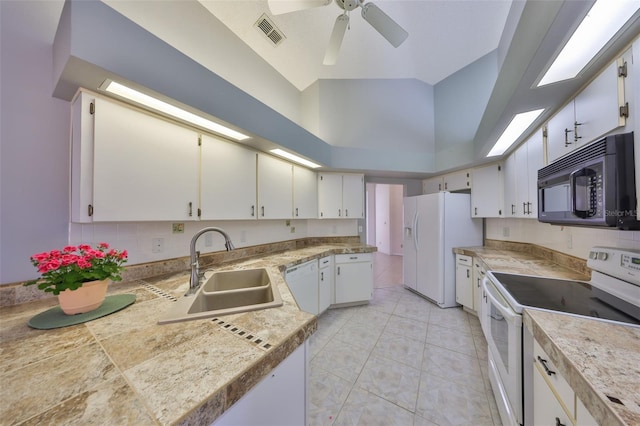 kitchen featuring white cabinetry, sink, and white appliances