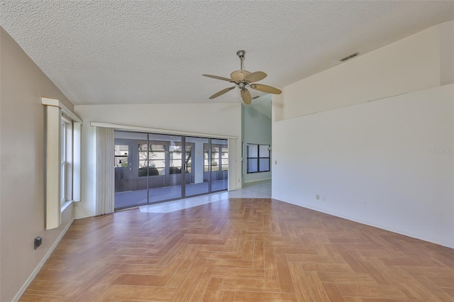 unfurnished room featuring lofted ceiling, ceiling fan, a textured ceiling, and light parquet flooring