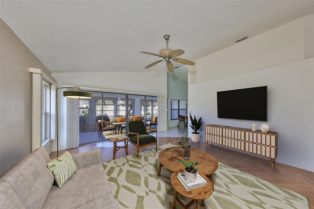 living room featuring parquet floors, ceiling fan, lofted ceiling, and a textured ceiling