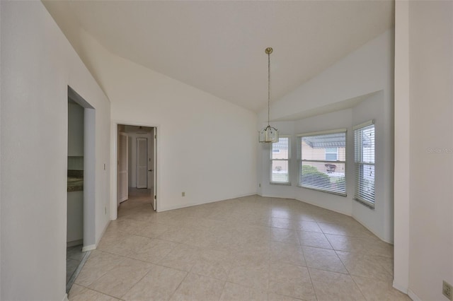 spare room with lofted ceiling and light tile patterned floors