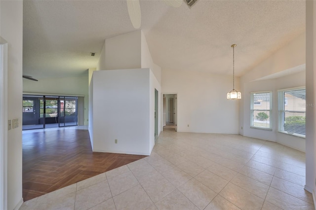 spare room with ceiling fan, light parquet floors, high vaulted ceiling, and a textured ceiling