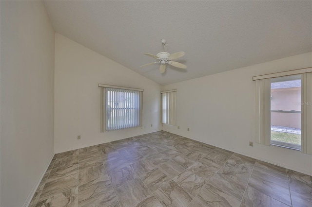 unfurnished room with ceiling fan, lofted ceiling, and a textured ceiling