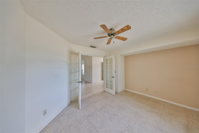 unfurnished bedroom with a textured ceiling, french doors, and ceiling fan