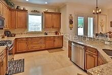 kitchen with appliances with stainless steel finishes and hanging light fixtures