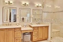 bathroom featuring vanity and tiled shower