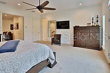 bedroom with light colored carpet and ceiling fan