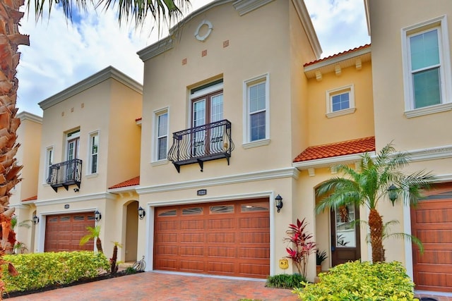 3222 W Empedrado St, Tampa, FL 33629 - mediterranean / spanish home with stucco siding, a tile roof, an attached garage, and decorative driveway