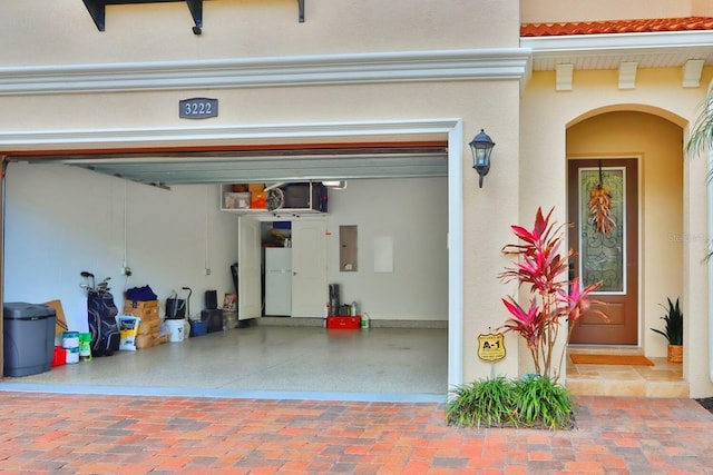 3222 W Empedrado St, Tampa, FL 33629 - garage with freestanding refrigerator, decorative driveway, and electric panel