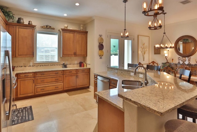 3222 W Empedrado St, Tampa, FL 33629 - kitchen featuring backsplash, a sink, a breakfast bar, brown cabinetry, and an inviting chandelier